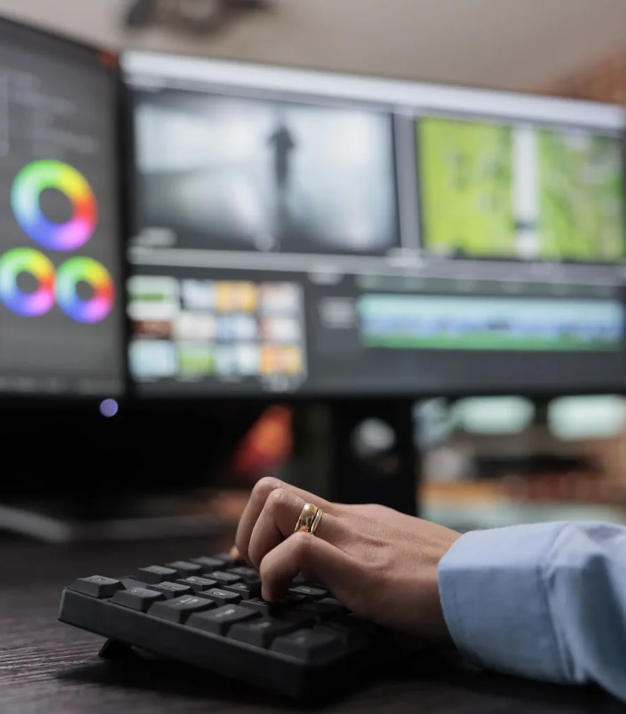 Analyst reviewing footage and color-grading tools on multi-monitor workstation for 3D/4D visual case reconstruction